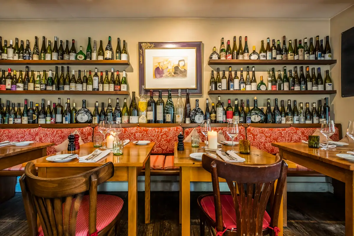 Table avec des bouteilles de vin sur le mur.