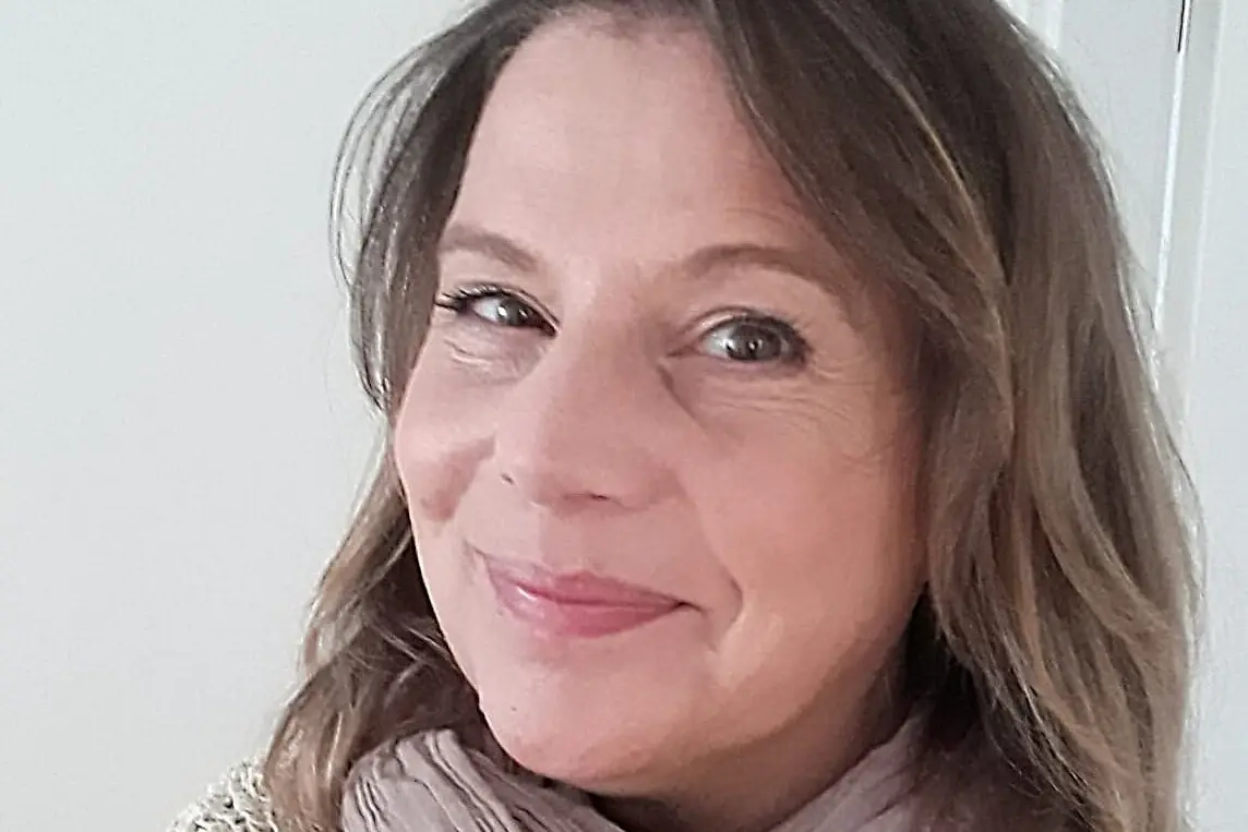 Maren Vöge Eine Frau lächelt für ein Selfie und trägt einen Schal.