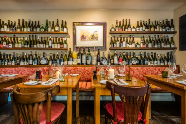 Table avec des bouteilles de vin sur le mur.